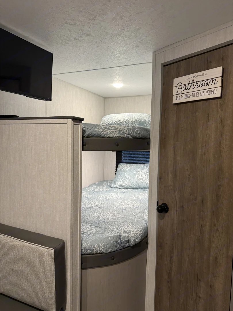 Cozy dual bunks near bathroom